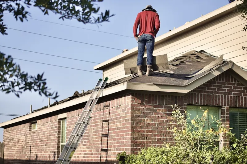 Professional roofer working on a residential roof in Parole